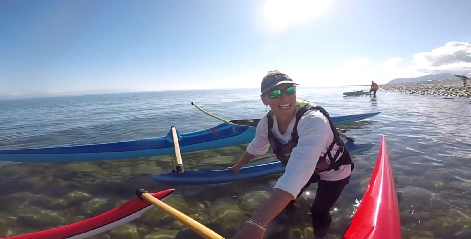 Zoe holdinh waka on the Boulder Bank in Nelson
